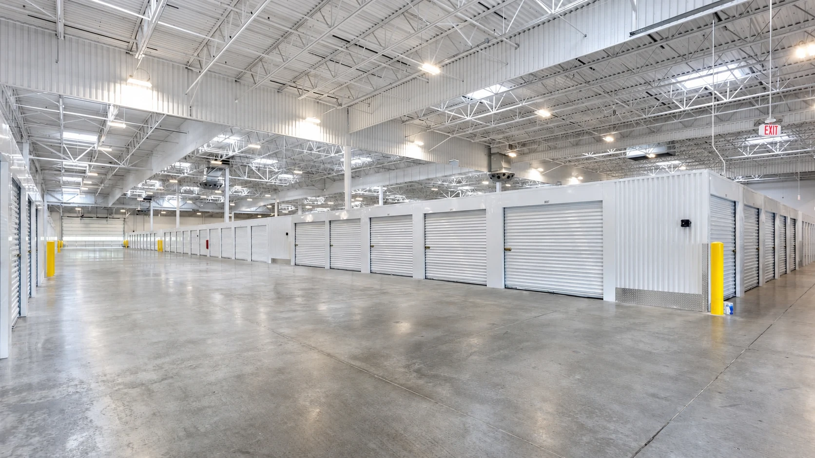 Interior self-storage conversion with white roll-up doors