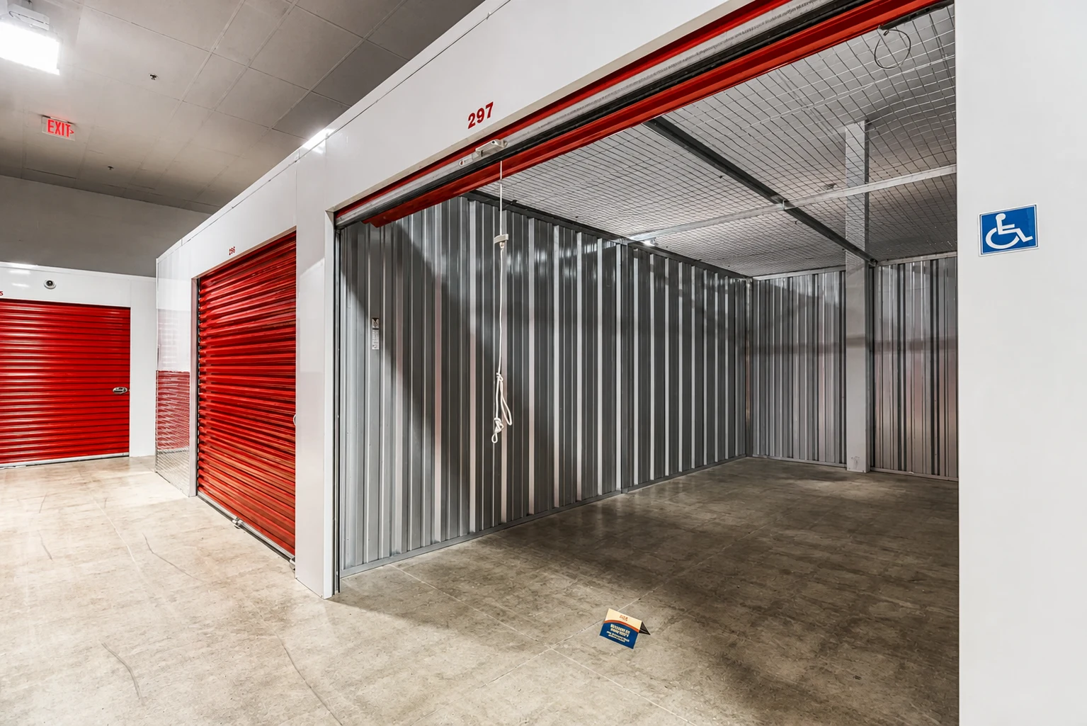 Interior retrofit with red roll-up doors and an open storage unit