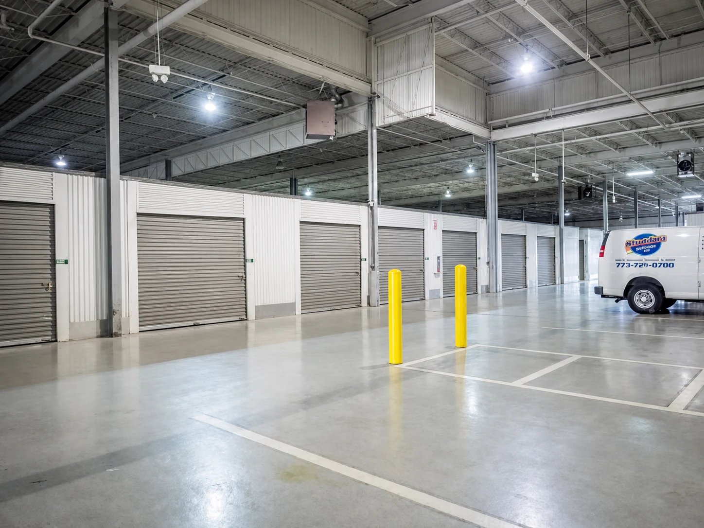 Self-storage retrofit with gray doors and interior drive aisle